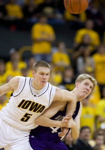 Iowa's Matt Gatens (5) fights for a loose ball with Northwestern's Kevin Coble during the first half of an NCAA college basketball game, Feb. 7, 2009, in Iowa City, Iowa. (AP Photo/Charlie Neibergall)