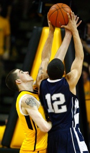 Iowa's Jake Kelly, left, blocks a shot by Penn State's Talor Battle, right, during the second overtime March 7. Iowa won 75-67, in double overtime. (AP Photo /Matthew Putney)