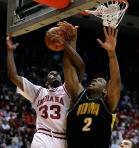 Iowa center David Palmer (2) is fouled by Indiana guard Devan Dumes as he goes up for a shot during the first half  of an NCAA college basketball game in Bloomington, Ind., Feb. 4, 2009. (AP Photo/Darron Cummings)