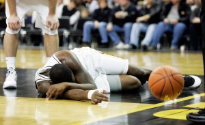 Iowa's Cyrus Tate (44) lies on the court after injuring his knee during the first period of their game against Minnesota at Carver Hawkeye Arena on Thursday, Jan. 8, 2009.