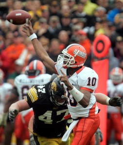 Illinois' quarterback Eddie McGee (10) lets go of the ball as he is hit by Iowa's Mitch King (47) during the second half Oct. 13, 2007 at Kinnick Stadium.  Iowa beat No. 18 Illinois 10-6. (AP Photo/Brian Ray)