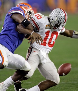 Florida defensive end Jarvis Moss (94) forces a fumble against Ohio State quarterback Troy Smith (10) in the BCS title game at Glendale, Ariz., on Jan. 8, 2007. (AP Photo/Ted S. Warren)