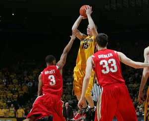 Iowa's Devan Bawinkel (15) pulls up for a three-point shot over Ohio State's Walter Offutt (3) and Jon Diebler (33) during the second half of their college basketball game Tuesday, March 3, 2009 at Carver-Hawkeye Arena in Iowa City. Bawinkel went 8 for 13 from behind the three-point line. Iowa lost 60-58.  (Brian Ray/The Gazette)