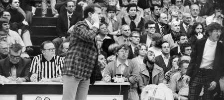 First-year Cyclone head basketball coach Ken Trickey (plaid suit, center) reacts to action on the floor of the Iowa Fieldhouse in Iowa City in 1974. Iowa won, 77-66. (Gazette photo)