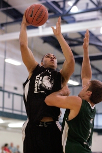 Imprinted Sportswear/Goodfellow Printing's Aaron Fuller (24) pulls up for a shot over Mike Gatens Real Estate/McCurry's Eric May (7) during their game on the opening night of the Prime Time league Monday, June 15, 2009 at the North Liberty Community Center.  (Brian Ray/The Gazette)