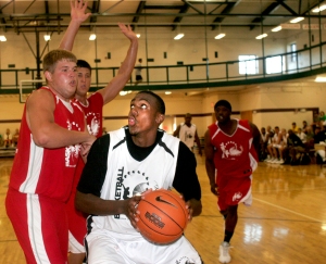 Iowa forward Devon Archie takes the ball up strong against Iowa post Brennan Cougill during PrimeTime League action at the North Liberty Community Center on Monday, June 29, 2009. (Benjamin Roberts/Freelance)